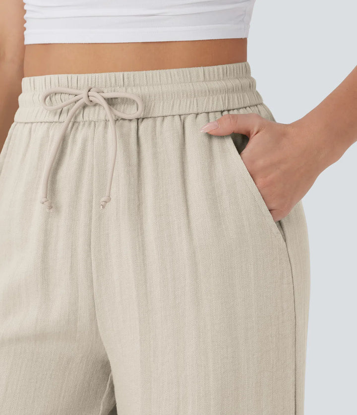 Pantalon décontracté taille haute, poches et cordon de serrage, jambes larges, aspect lin.