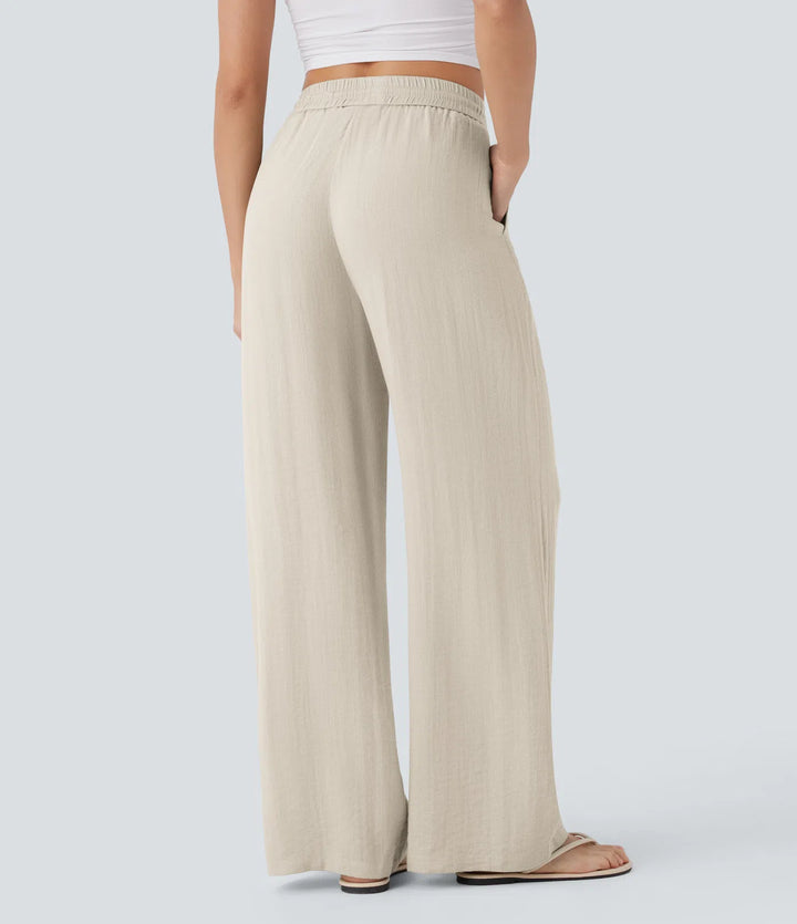 Pantalon décontracté taille haute, poches et cordon de serrage, jambes larges, aspect lin.